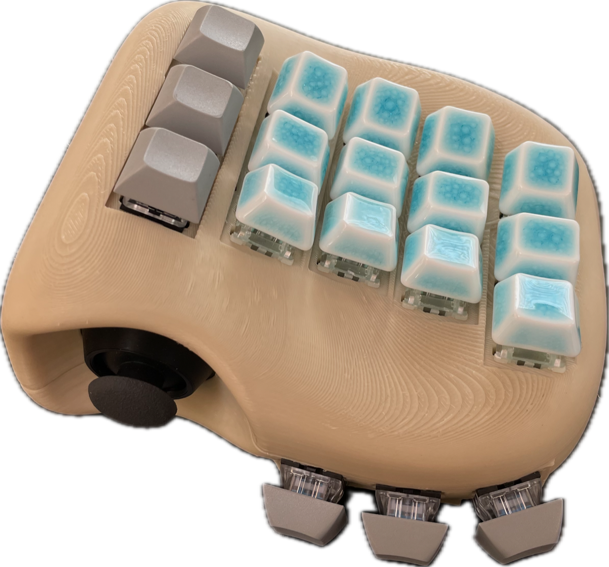 The kymecreo prototype: a Skeletyl-derived ergo-split enclosure, sculpted Sculpey and re-modeled in Fusion 360, with resin-printed hall-effect switches glowing blue under a row of keycaps.